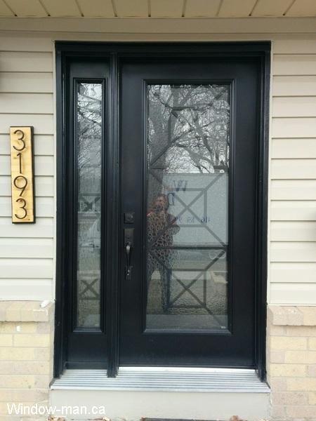 Single insulated steel entry front door with one sidelight. Painted in spray booth Black. Modern design. Townsbridge iron glass inserts